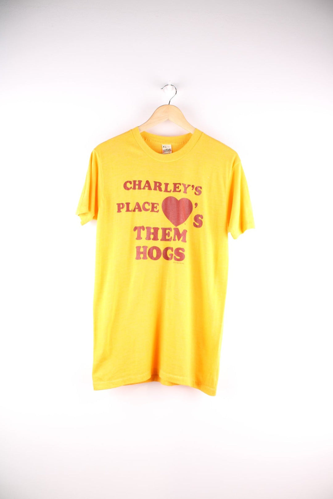 Vintage Screen Stars graphic T-Shirt in a yellow colourway. The shirt has a large red slogan printed on the front. Made in the USA. 