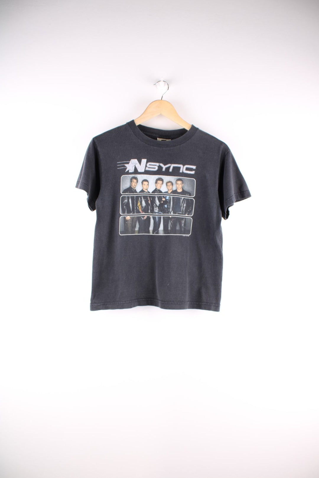 Vintage N Sync baby tee in a washed black colourway. The shirt has a large graphic image of the band printed on the front, and is dated to the year 2000. 