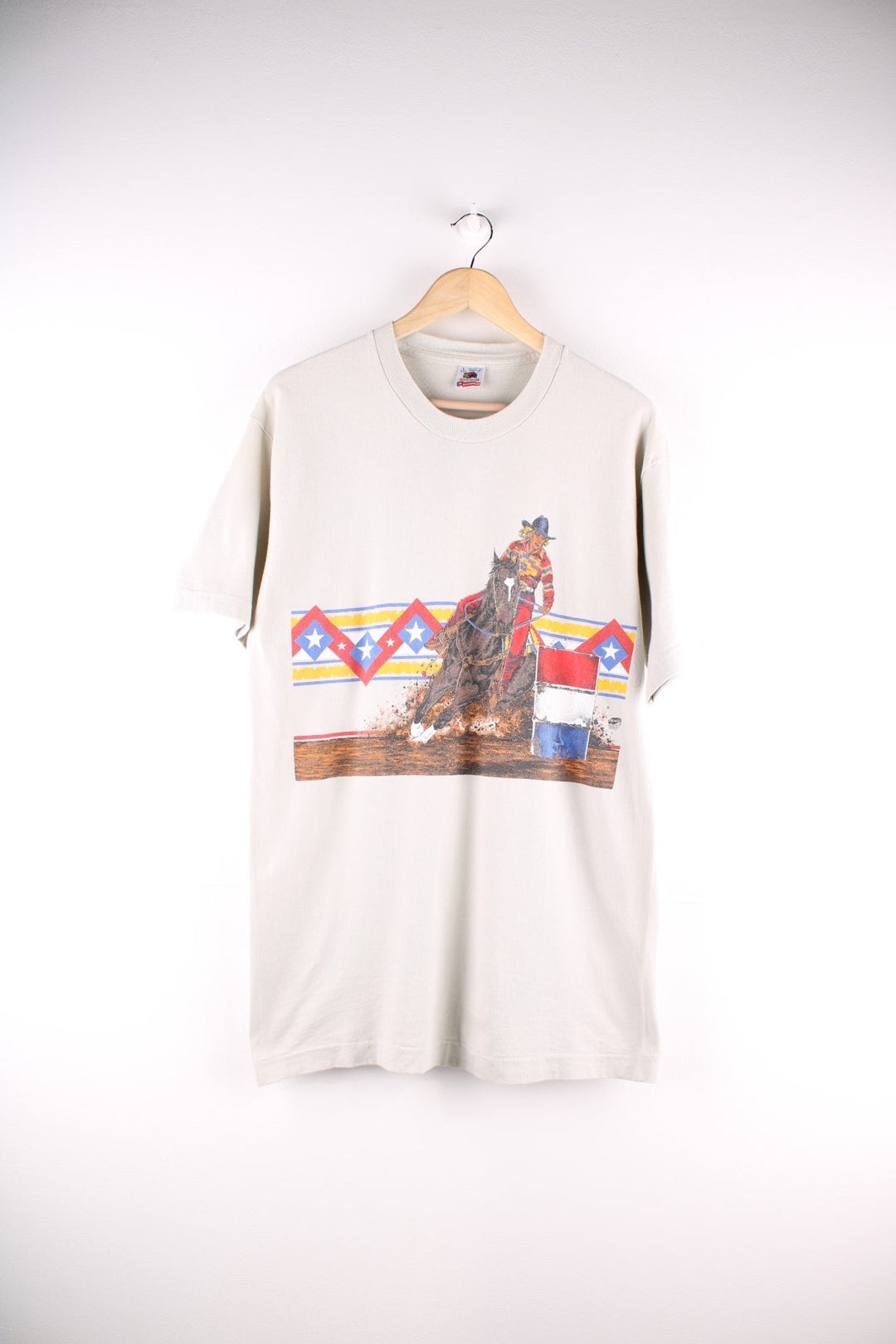 Vintage Fruit of the Loom western style graphic T-Shirt in a tan/beige colourway. The shirt has has graphic of a cowgirl and horse, with an aztec pattern and is dated to 1995.   