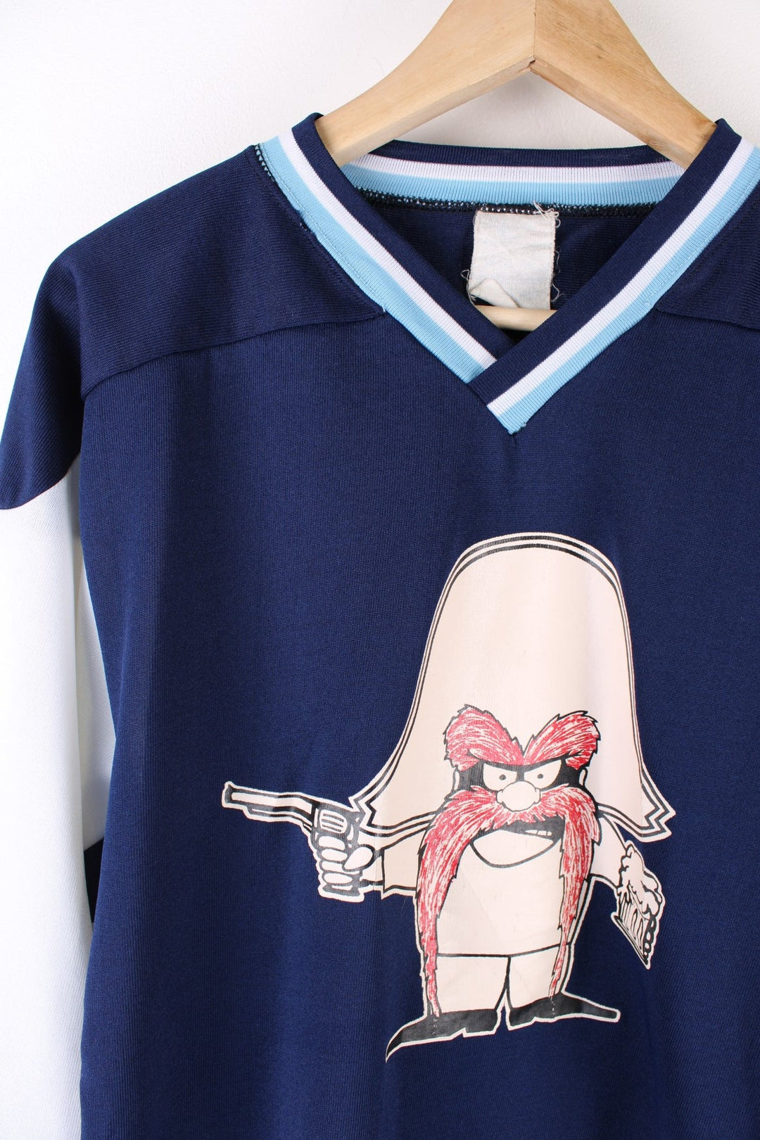 Vintage 90's Looney Tunes Bandit Hockey Jersey in a blue colourway with the bandit graphic printed on the front and on the back is Bandits number 4.