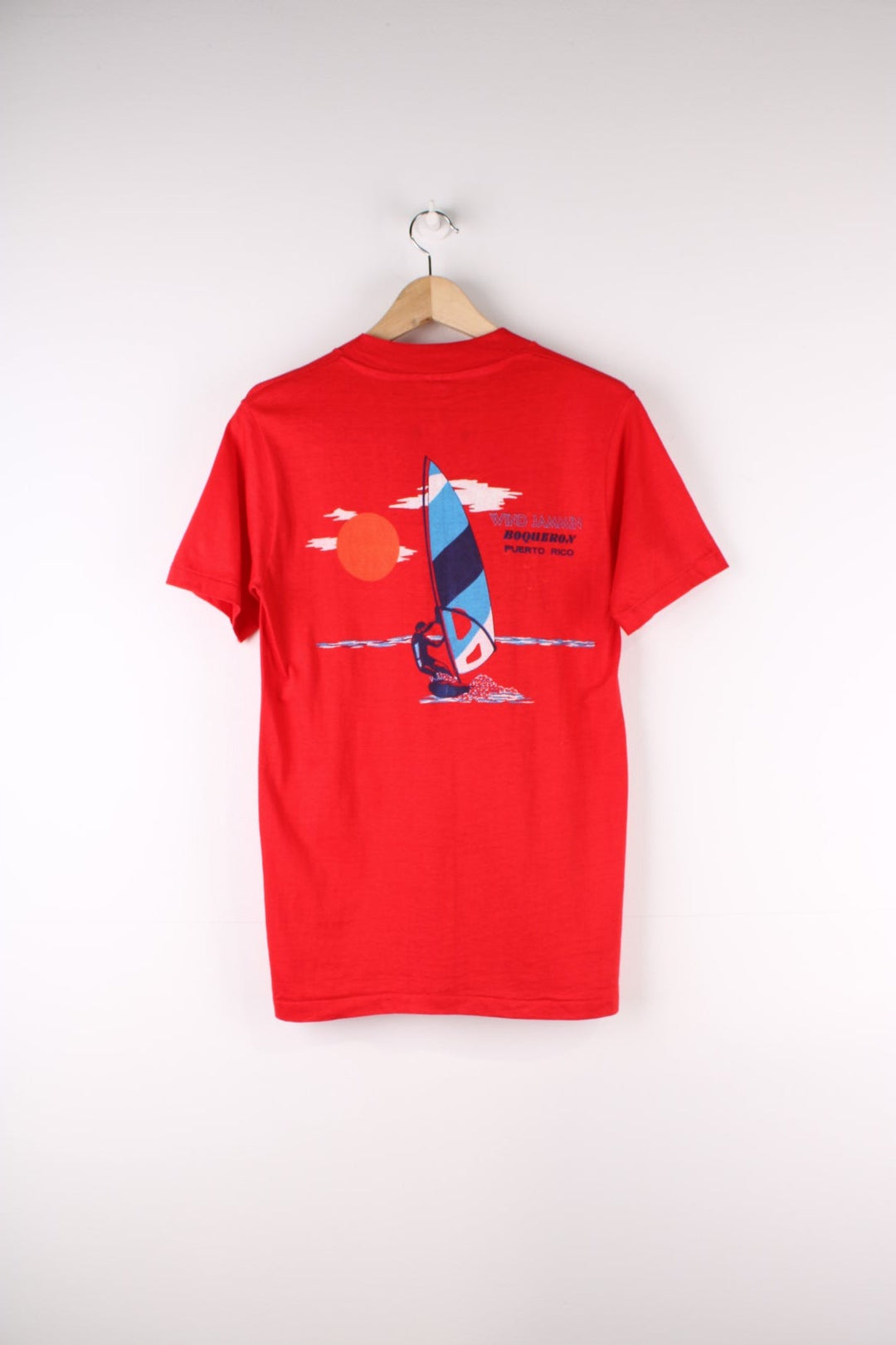 Vintage Mona Island Puerto Rico Graphic T-Shirt in a red colourway with the spell out printed on the chest pocket and on the back a surfing graphic printed.