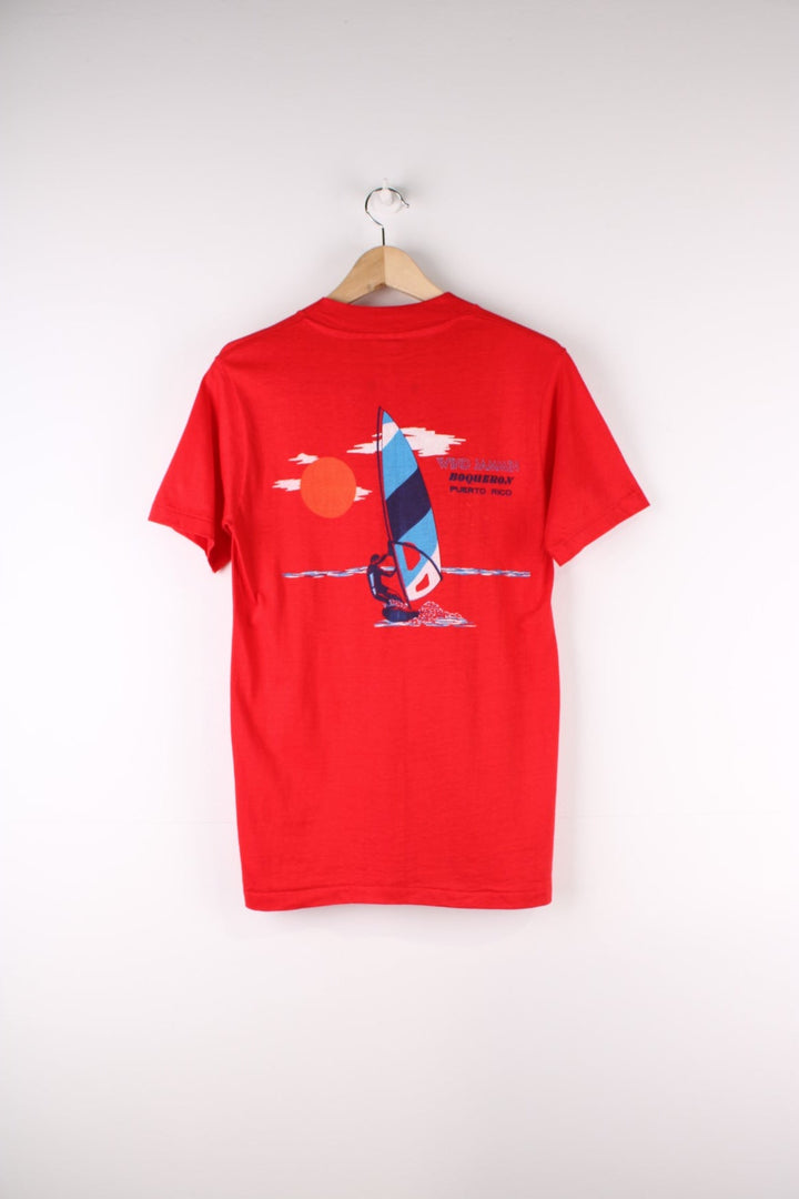 Vintage Mona Island Puerto Rico Graphic T-Shirt in a red colourway with the spell out printed on the chest pocket and on the back a surfing graphic printed.