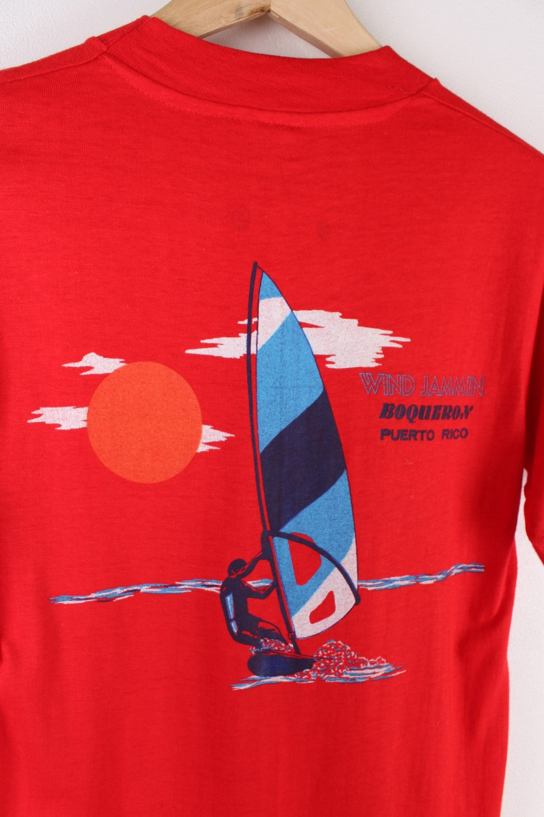 Vintage Mona Island Puerto Rico Graphic T-Shirt in a red colourway with the spell out printed on the chest pocket and on the back a surfing graphic printed.