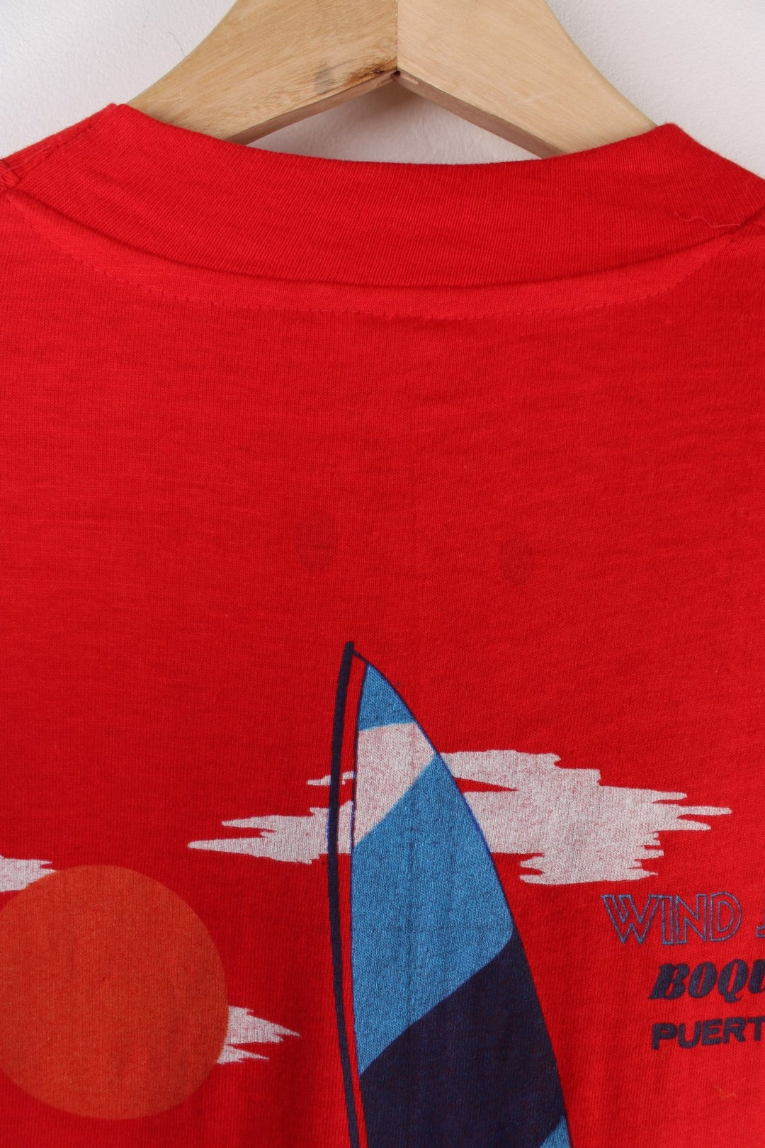 Vintage Mona Island Puerto Rico Graphic T-Shirt in a red colourway with the spell out printed on the chest pocket and on the back a surfing graphic printed.