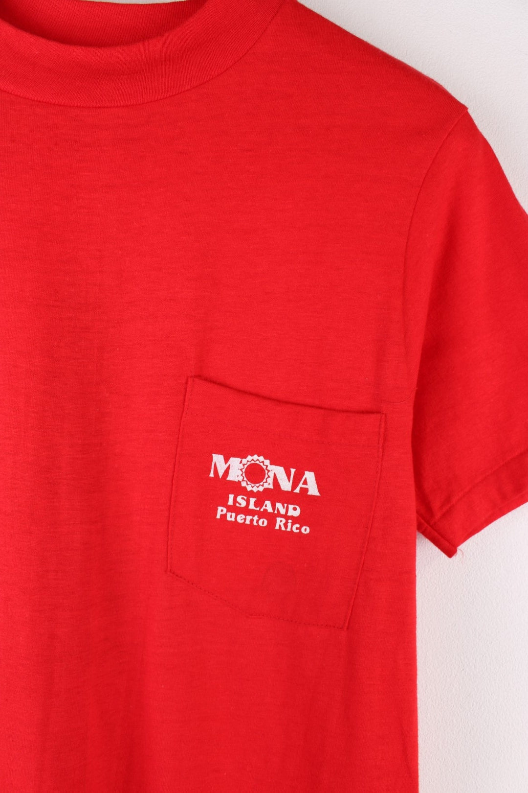 Vintage Mona Island Puerto Rico Graphic T-Shirt in a red colourway with the spell out printed on the chest pocket and on the back a surfing graphic printed.