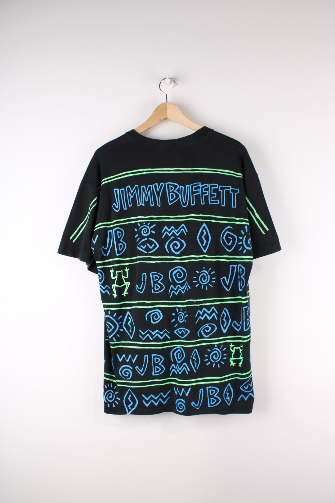 Vintage Jimmy Buffett Neon Surf Frog T-Shirt in a black colourway with neon patterns printed all over as well as surf frog graphic printed on front and on the back Jimmy Buffett spell out.