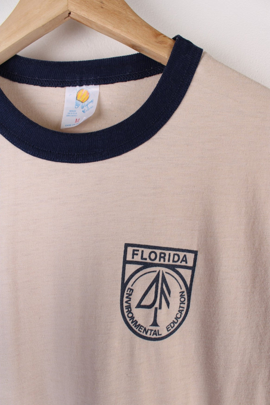 Vintage 70's Florida Environmental Education Ringer T-Shirt in a tan colourway with the logo printed on the front.