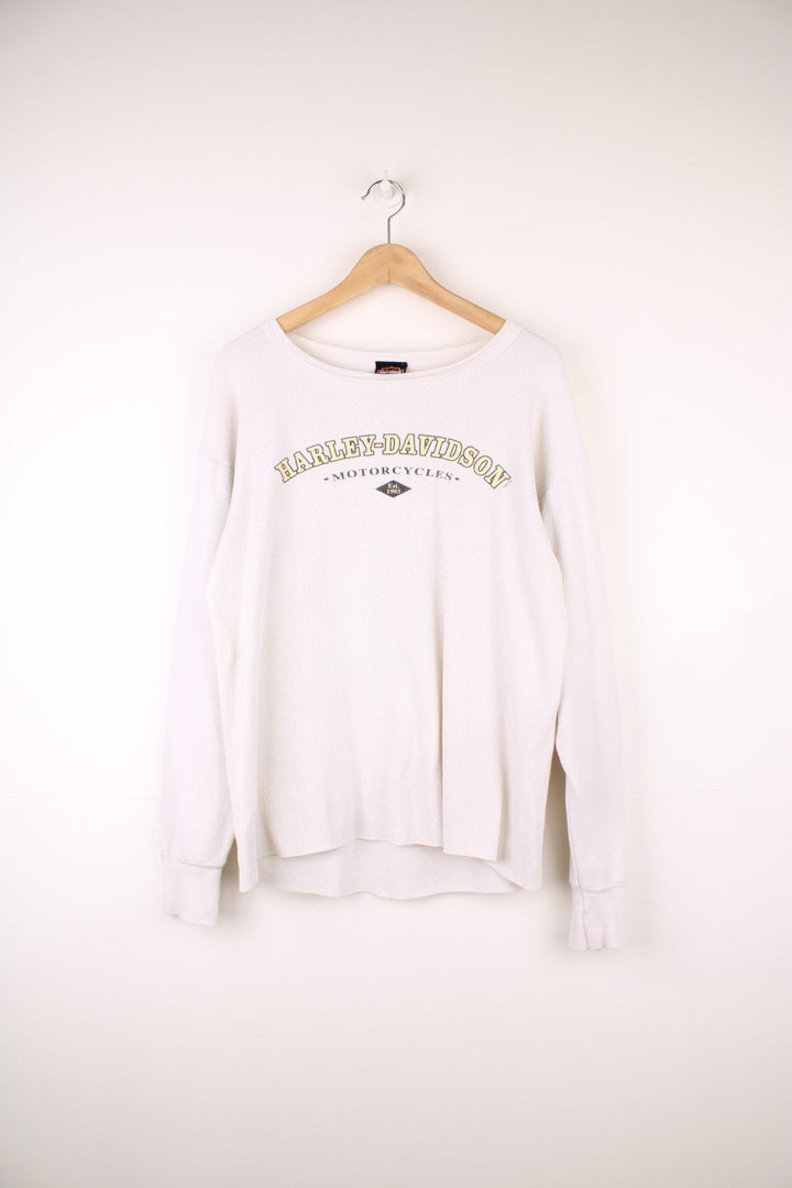 2001 Harley-Davidson, Daytona Beach, Florida long sleeved top in an off white/light beige colourway. Features printed spell out logo across the chest and graphic print on the back. 