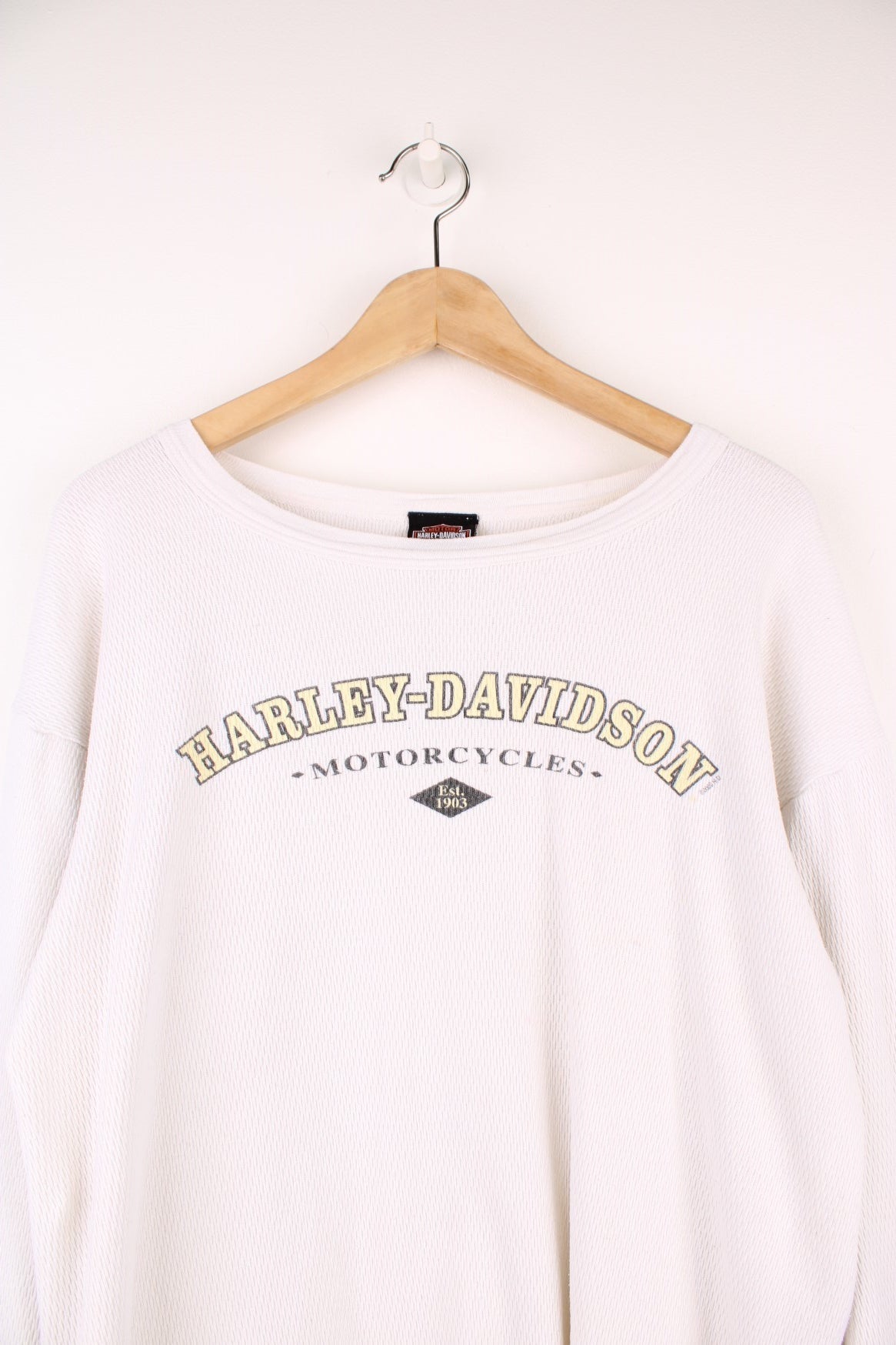 2001 Harley-Davidson, Daytona Beach, Florida long sleeved top in an off white/light beige colourway. Features printed spell out logo across the chest and graphic print on the back. 