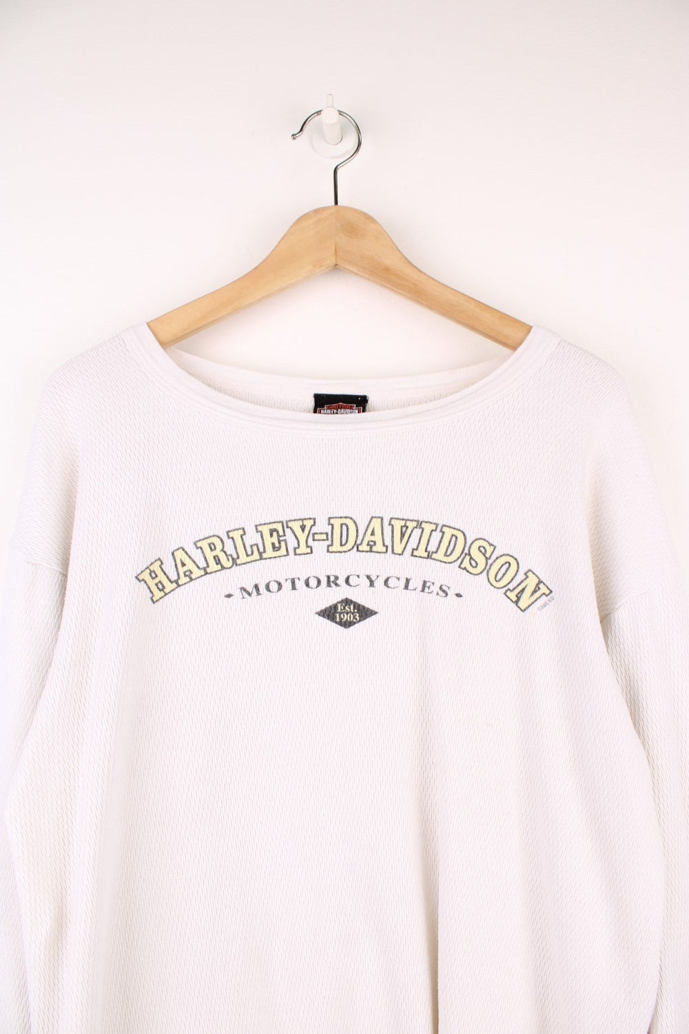 2001 Harley-Davidson, Daytona Beach, Florida long sleeved top in an off white/light beige colourway. Features printed spell out logo across the chest and graphic print on the back. 