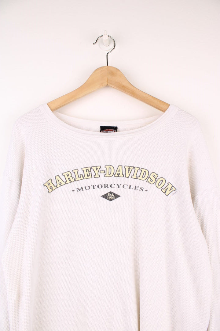 2001 Harley-Davidson, Daytona Beach, Florida long sleeved top in an off white/light beige colourway. Features printed spell out logo across the chest and graphic print on the back. 