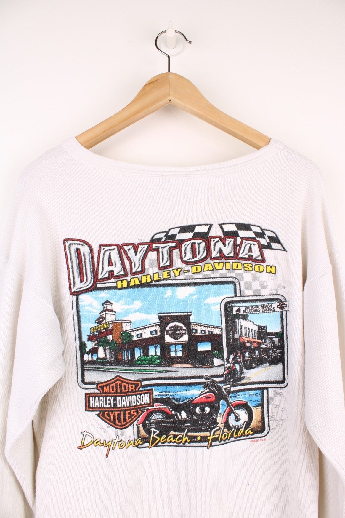 2001 Harley-Davidson, Daytona Beach, Florida long sleeved top in an off white/light beige colourway. Features printed spell out logo across the chest and graphic print on the back. 