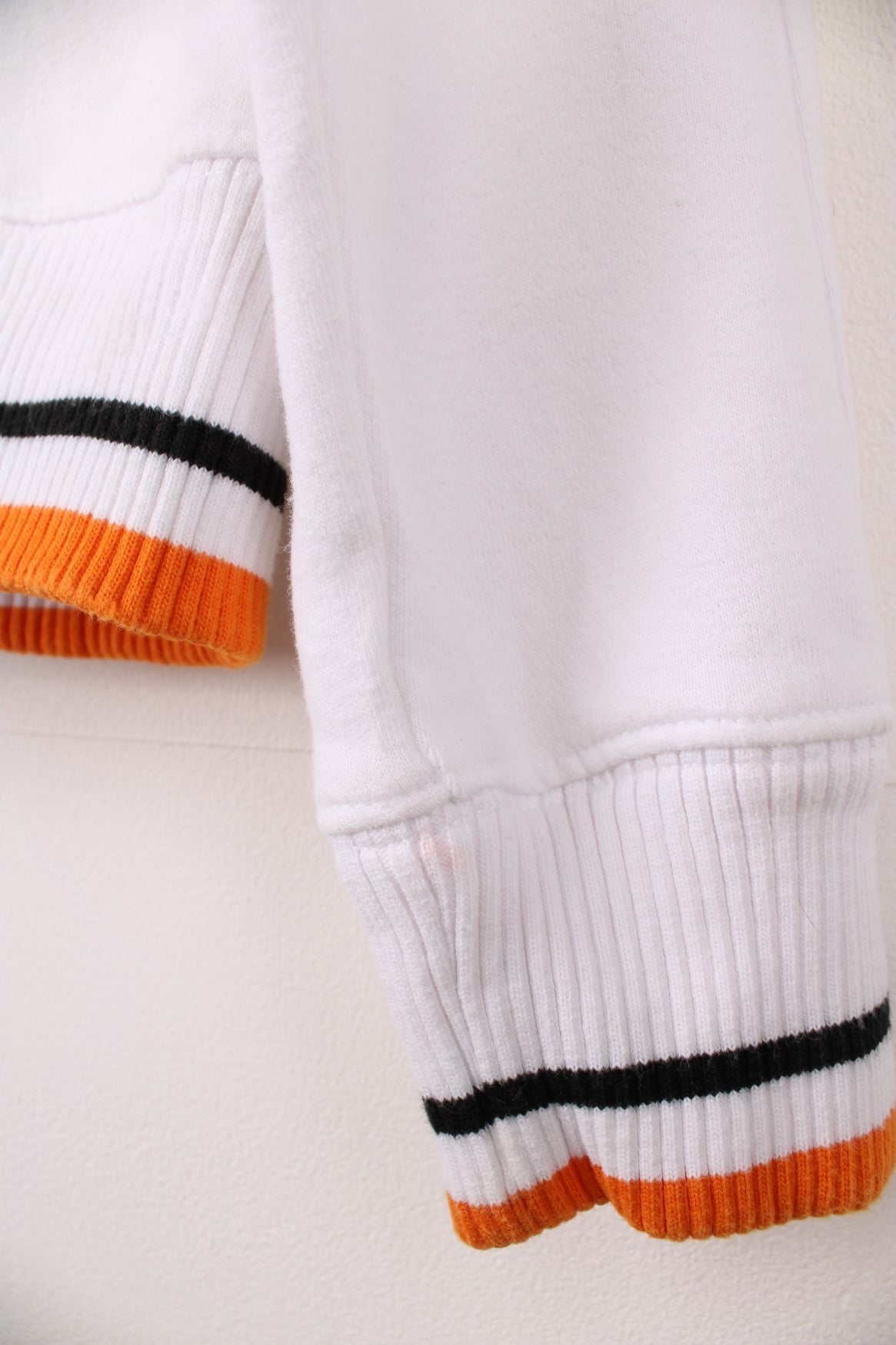 Harley-Davidson funnel neck zip through sweatshirt in a white, orange and black colourway. Features embroidered spell out logo across the chest and back.