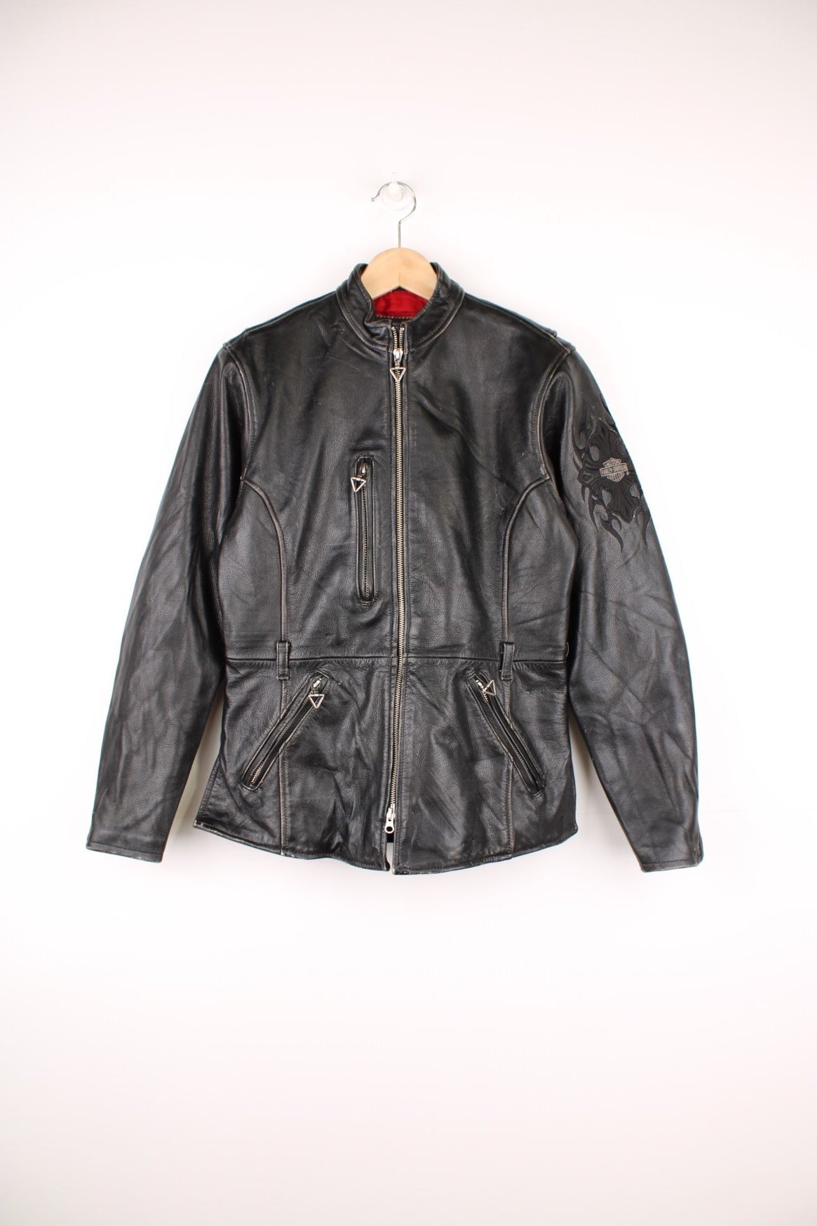 Vintage Harley-Davidson leather biker jacket with embroidered logo on the sleeve.