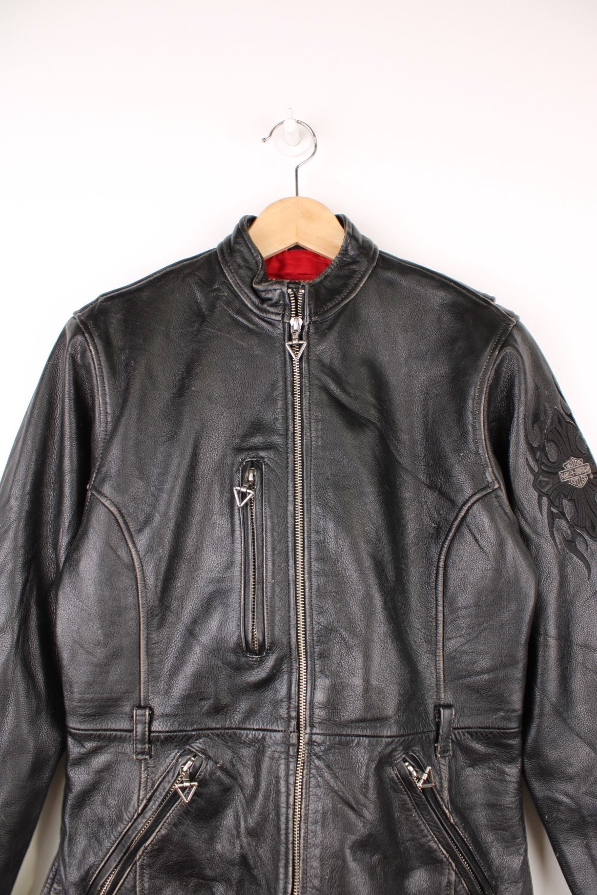 Vintage Harley-Davidson leather biker jacket with embroidered logo on the sleeve.