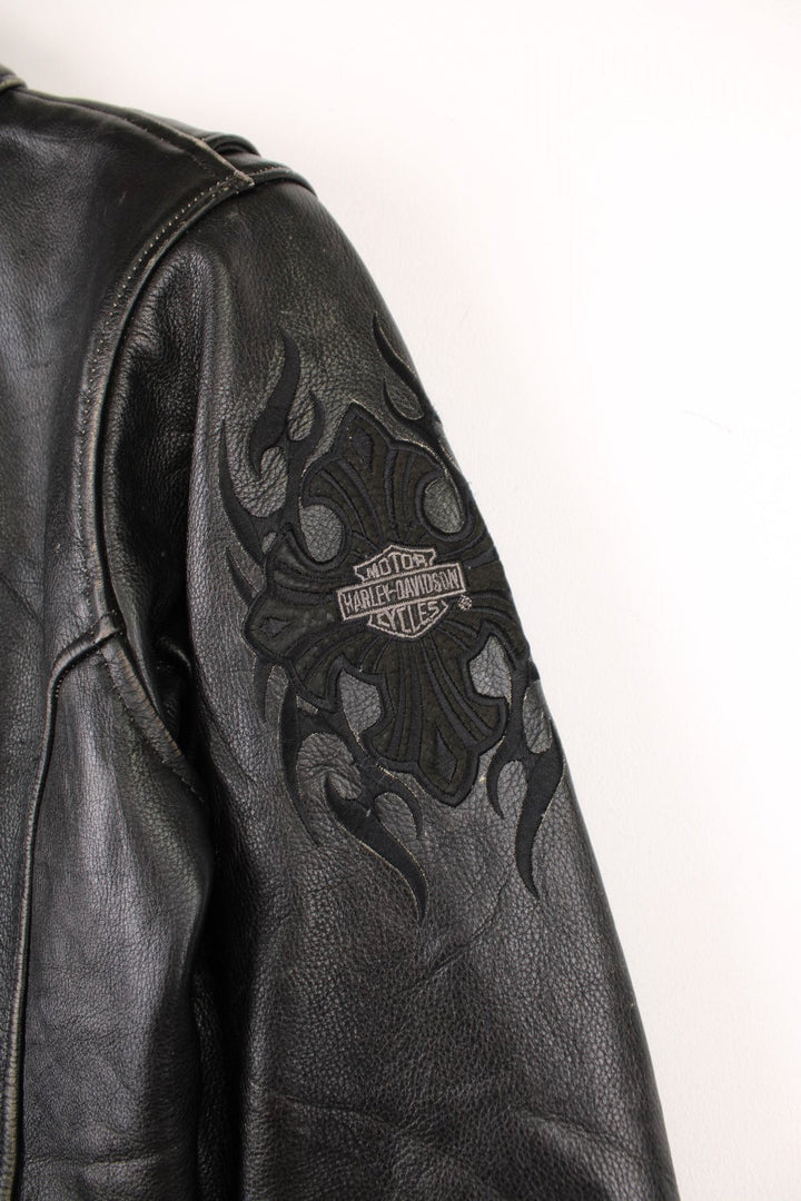 Vintage Harley-Davidson leather biker jacket with embroidered logo on the sleeve.