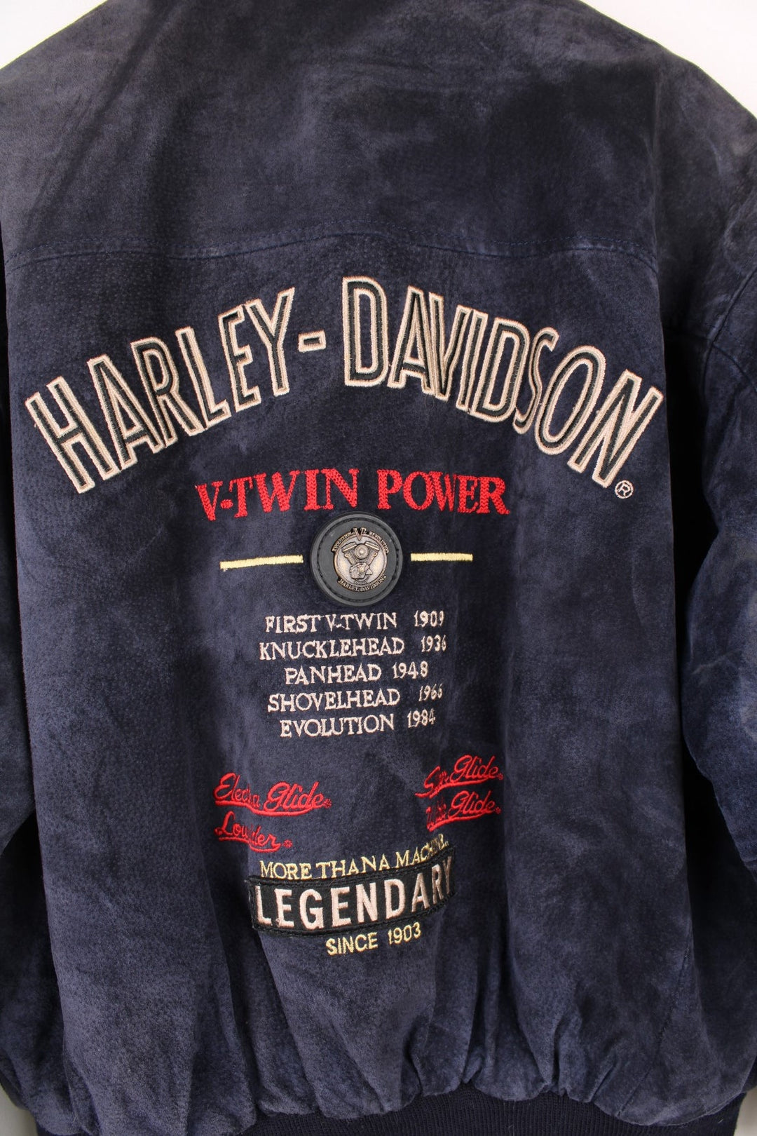 Vintage rare Harley-Davidson v-twin power navy blue suede bomber jacket with embroidered detail on the chest and large spell-out motif on the back with raised engine embellishments 