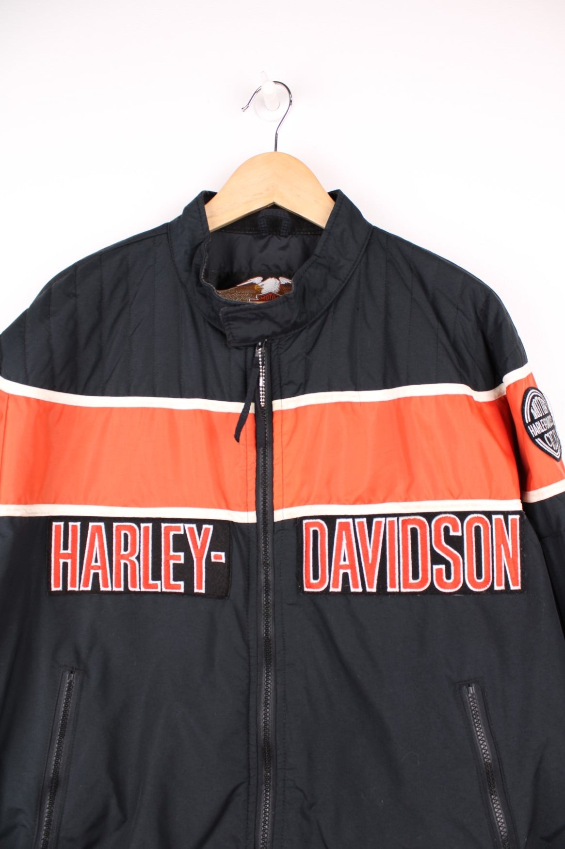 Harley-Davidson made in the USA black and orange motorcylce bomber jacket with embroiderd motif across the chest, badge on the shoulder and printed spell-out across the back of the shoulders