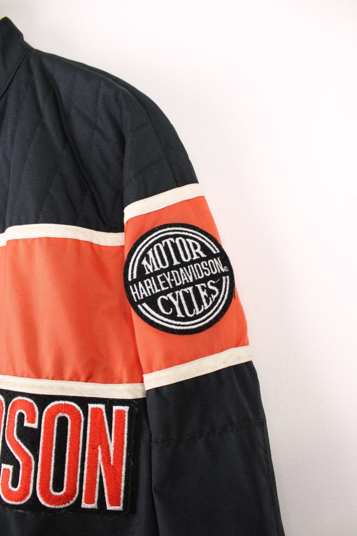 Harley-Davidson made in the USA black and orange motorcylce bomber jacket with embroiderd motif across the chest, badge on the shoulder and printed spell-out across the back of the shoulders