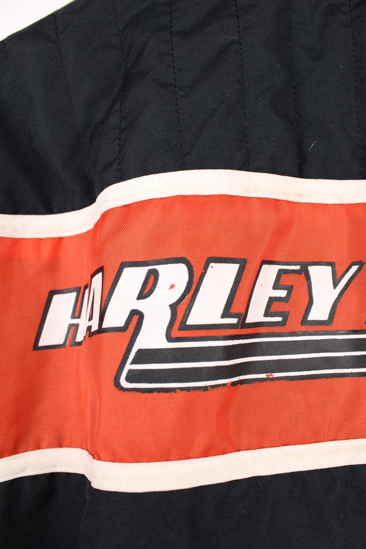 Harley-Davidson made in the USA black and orange motorcylce bomber jacket with embroiderd motif across the chest, badge on the shoulder and printed spell-out across the back of the shoulders