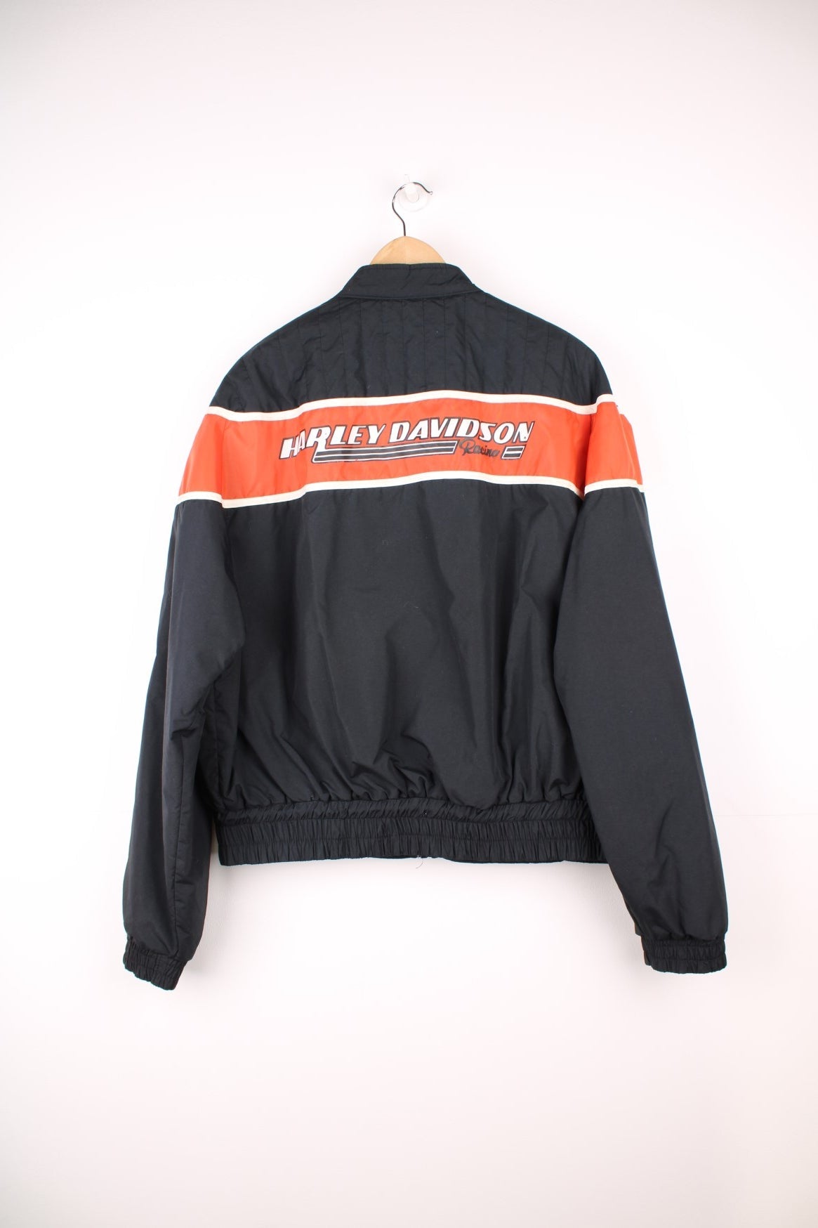 Harley-Davidson made in the USA black and orange motorcylce bomber jacket with embroiderd motif across the chest, badge on the shoulder and printed spell-out across the back of the shoulders