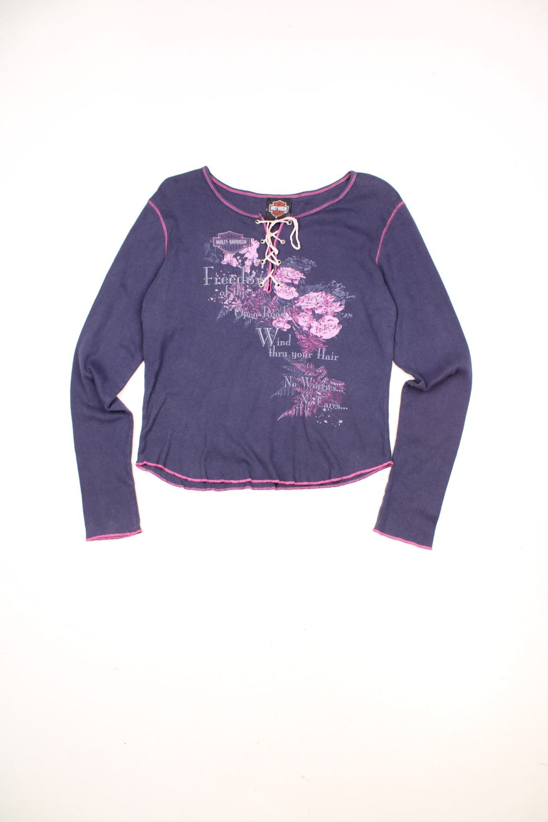 Harley-Davidson women's long sleeve top in purple with pink contrast stitching. Features printed graphic on the front and lace up detailing