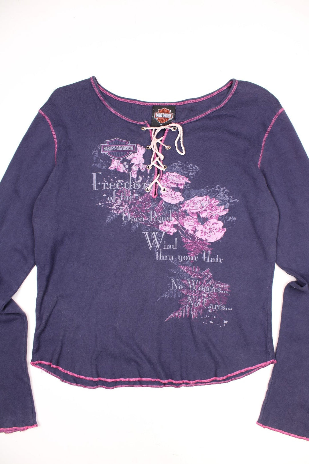 Harley-Davidson women's long sleeve top in purple with pink contrast stitching. Features printed graphic on the front and lace up detailing