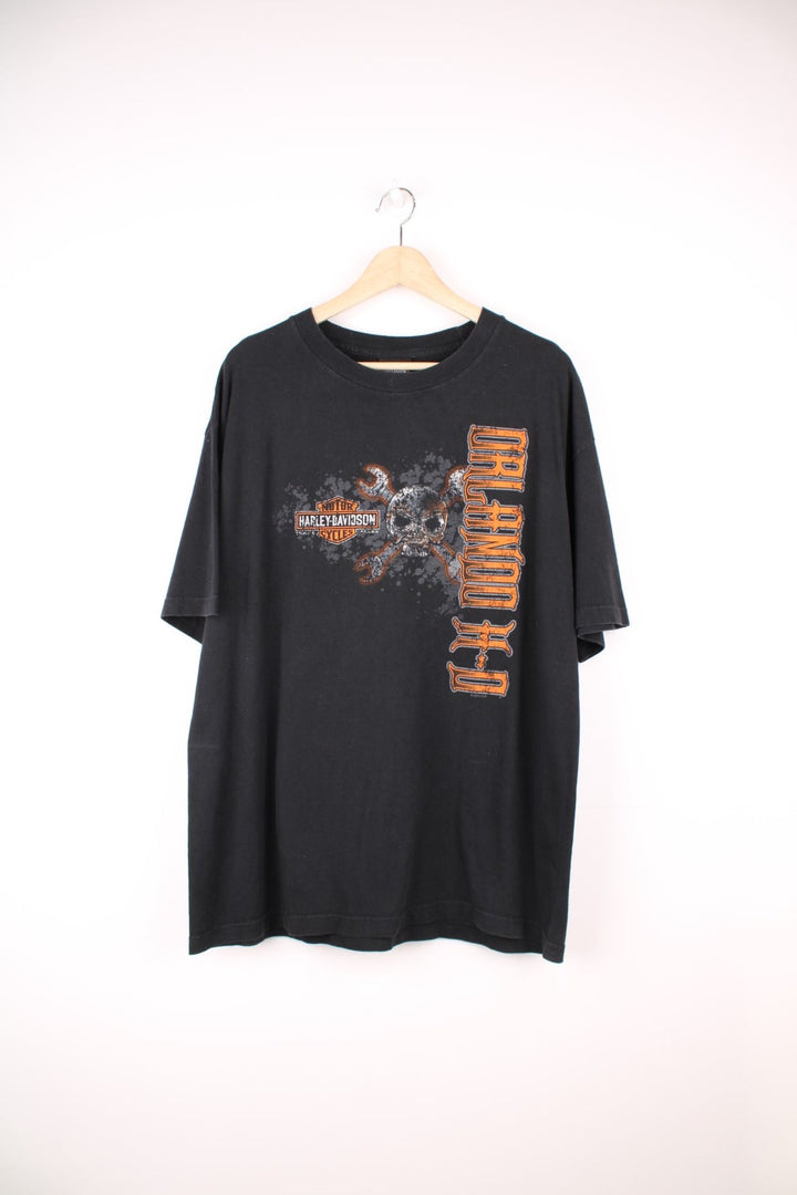 Harley Davidson Orlando, Florida USA T-Shirt in a black and orange colourway, has the logo spell out and skull and crossbones design printed on the front and back. 