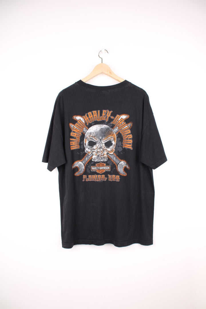 Harley Davidson Orlando, Florida USA T-Shirt in a black and orange colourway, has the logo spell out and skull and crossbones design printed on the front and back. 