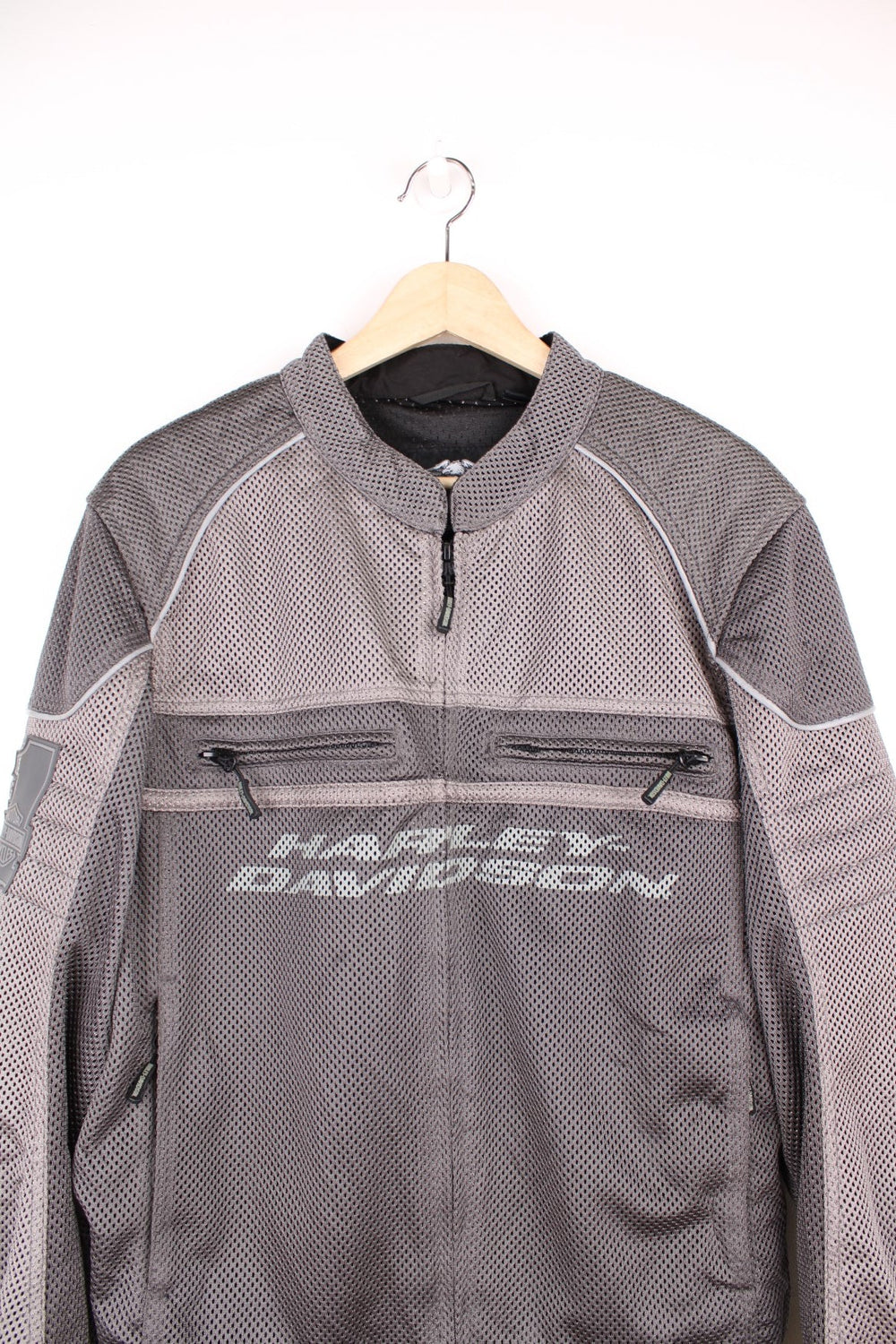 Harley Davidson Affinity Mesh Motorbike Jacket in a grey colourway, zip up with multiple pockets, and has the spell out logo printed on the front and back.