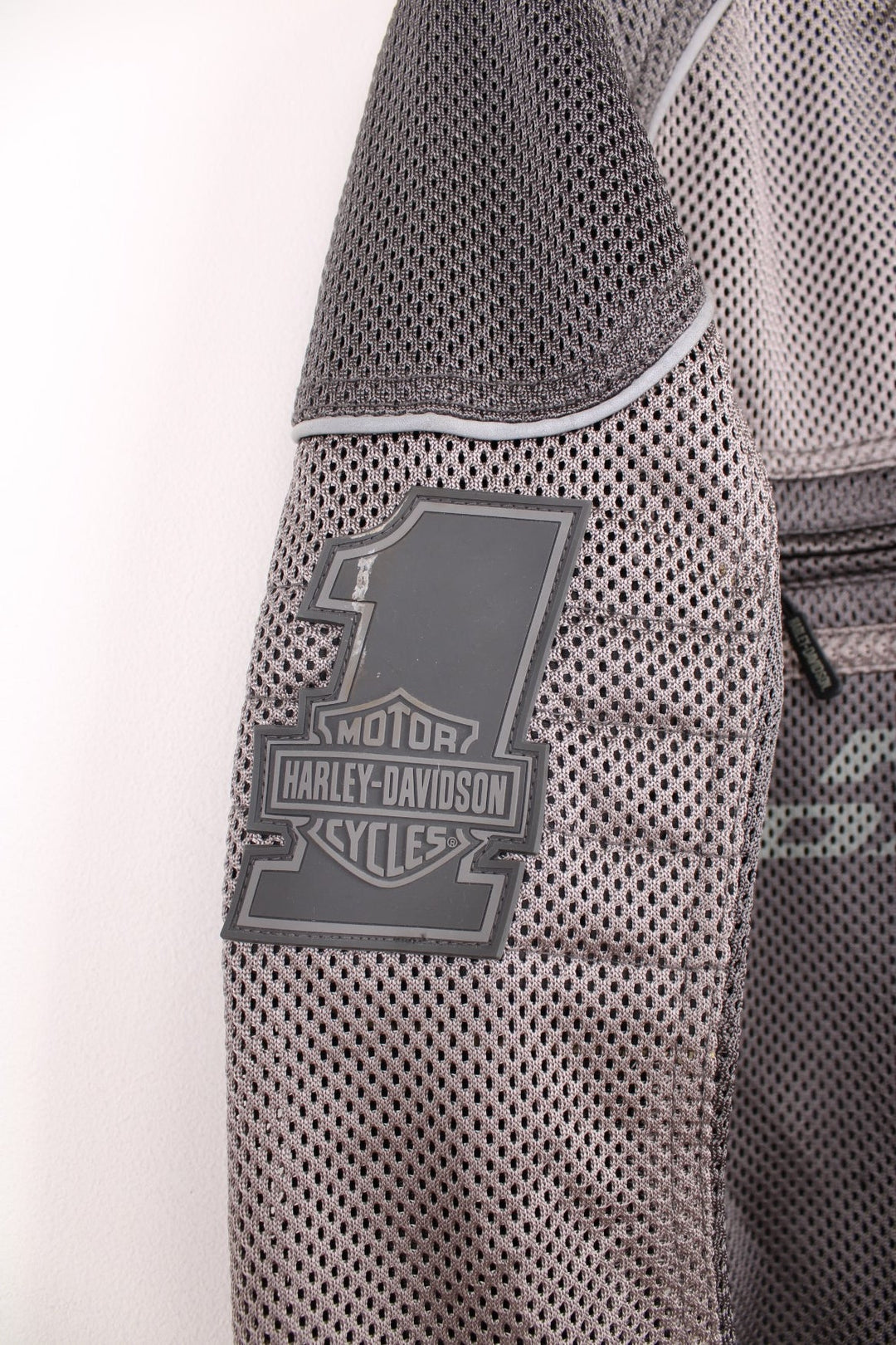 Harley Davidson Affinity Mesh Motorbike Jacket in a grey colourway, zip up with multiple pockets, and has the spell out logo printed on the front and back.