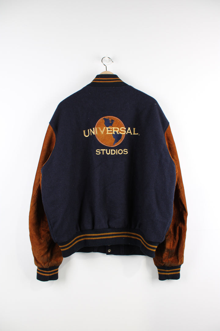 Vintage 00's Universal Studios blue and brown varsity jacket. Has a quilted lining and embroidered logo both on the front and back of the jacket. 