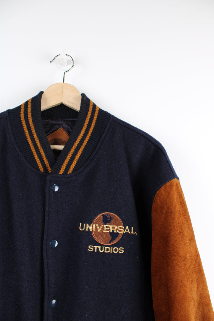 Vintage 00's Universal Studios blue and brown varsity jacket. Has a quilted lining and embroidered logo both on the front and back of the jacket. 