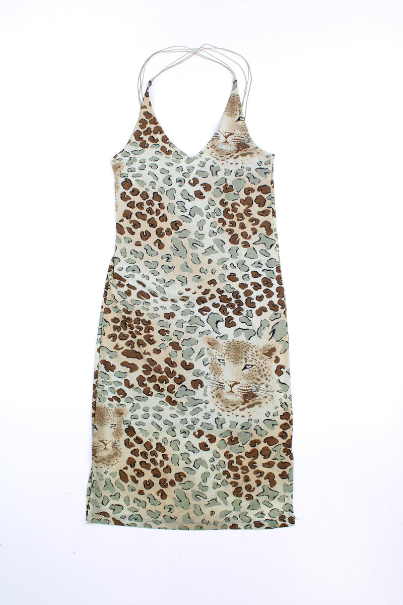 Vintage Y2K leopard print dress in green with criss-cross straps at the back. good condition Size in Label: No Size - Made from a stretchy fabric so could fit sizes S - L Our Measurements: Pit to pit: 17 inches (un-stretched) Length: 31 inches (from the back of the dress to the hem) 