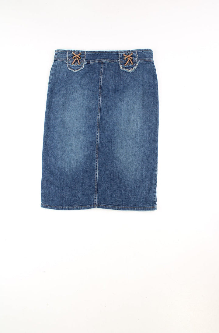 Vintage Y2K denim knee length skirt. Features western style lace up detail at the waistband and is made from a stretchy denim. Ment to be worn mid/ low rise but could be worn high-waisted depending on measurements. 