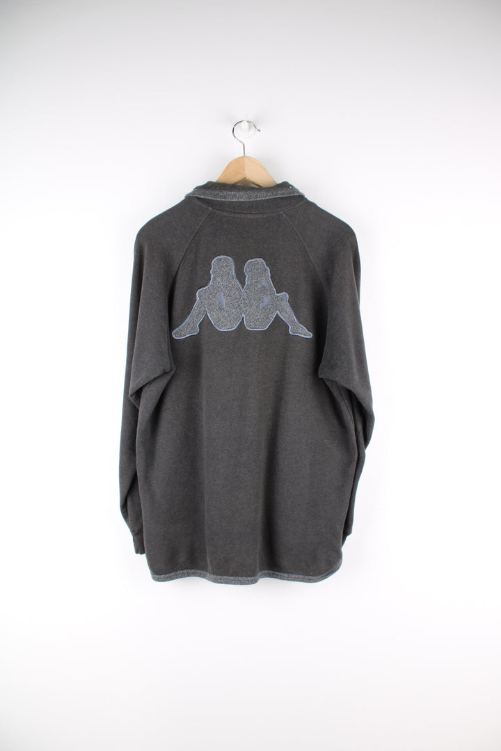 Kappa Sweatshirt in a grey colourway, quarter zip up, and has the logo embroidered on the front and back.