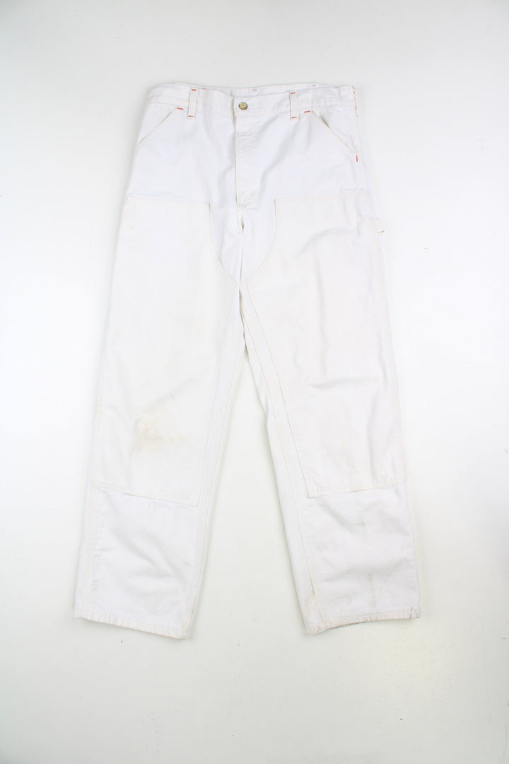 Carhartt double knee carpenter jeans in white, with multiple pockets with logo on the back pocket