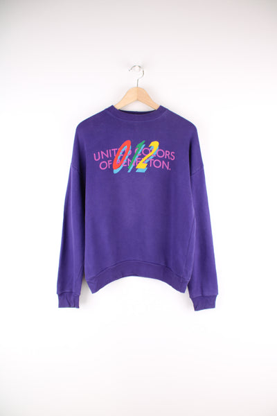 Vintage Benetton Sweatshirt in a purple colourway, crewneck, and has 'United Colors Of Benetton' spell out printed across the front.