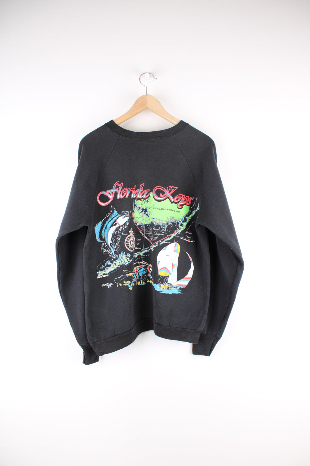 Vintage Florida Keys Graphic Sweatshirt in a black colourway, it has 'Florida Keys' printed on the front then has a big Florida map graphic printed on the back.