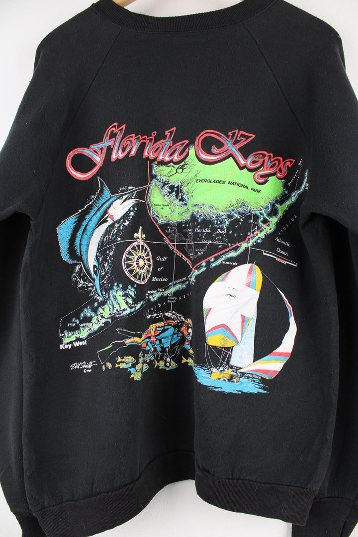 Vintage Florida Keys Graphic Sweatshirt in a black colourway, it has 'Florida Keys' printed on the front then has a big Florida map graphic printed on the back.