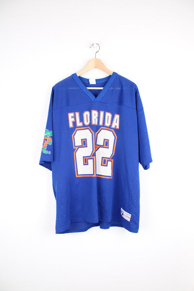 Vintage Florida Gators University Football Jersey in the blue, white and orange team colourway, logo 7 label, Emmitt Smith number 22 jersey, v neck, and has the logos printed on the front, back and both sleeves.