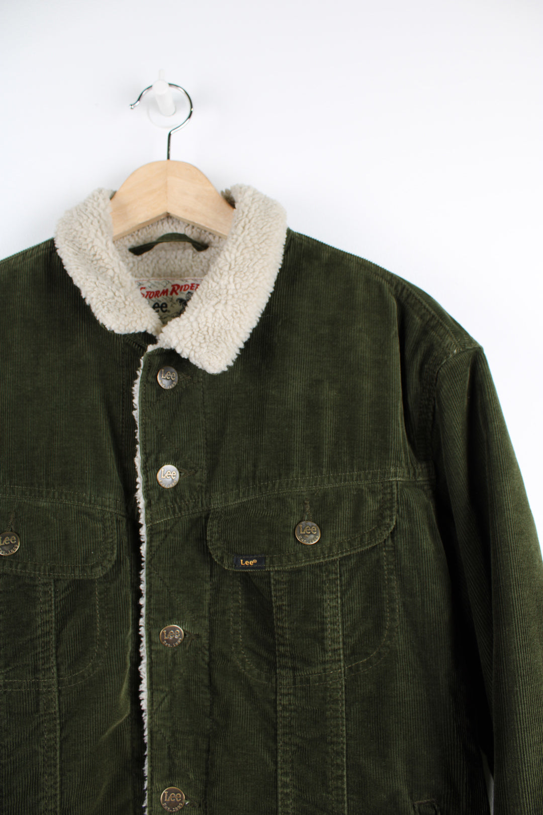 Vintage Lee Storm Rider corduroy jacket in green, button up with multiple pockets, and has a white sherpa lining. 