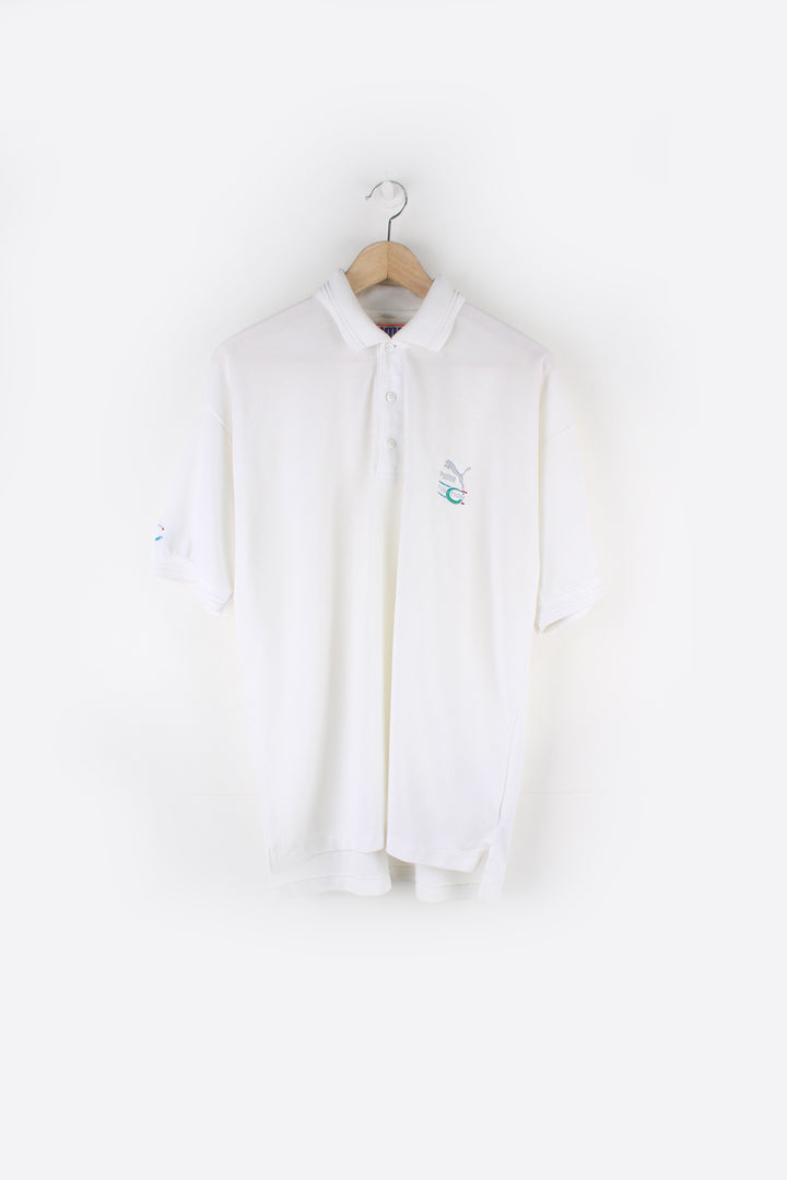 Puma Function Polo Shirt in a white colourway, button up collar, short sleeved and has the logo embroidered on the front and back.