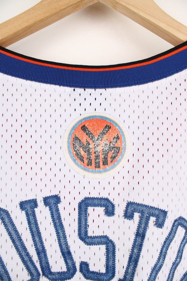 Vintage New York Knicks NBA Nike Jersey in the white, blue and orange team colourway, Allan Houston number 20 jersey, v neck and has the logos and numbers embroidered onto the front and back.