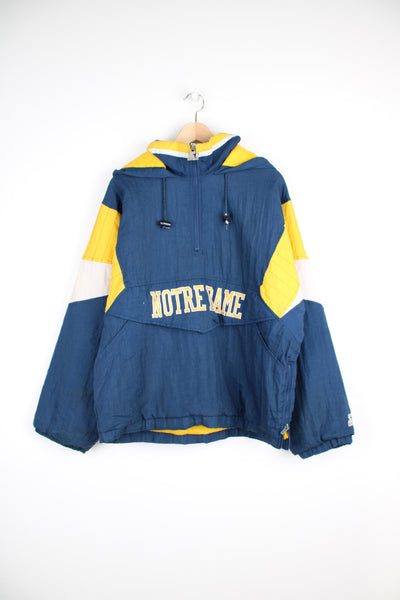 Vintage Starter, Norte Dame Fighting Irish Football Team Pullover Jacket in a blue, yellow and white colourway, half zip with big pouch pockets, hooded, insulated with a quilted lining and has the spell out and logo embroidered on the front and back.