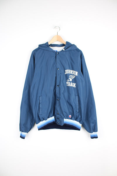 Vintage Champion Lightweight Jacket in a blue colourway, hooded, button up with side pockets, and has 'Johnson Track' printed on the front as well as the Champion logo embroidered underneath.