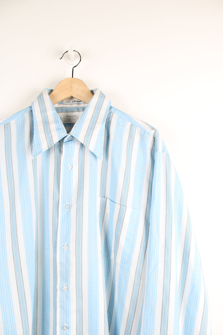 Vintage 70's blue and white striped button up shirt. Has a dagger collar and also printed info about the shirt at the bottom. 