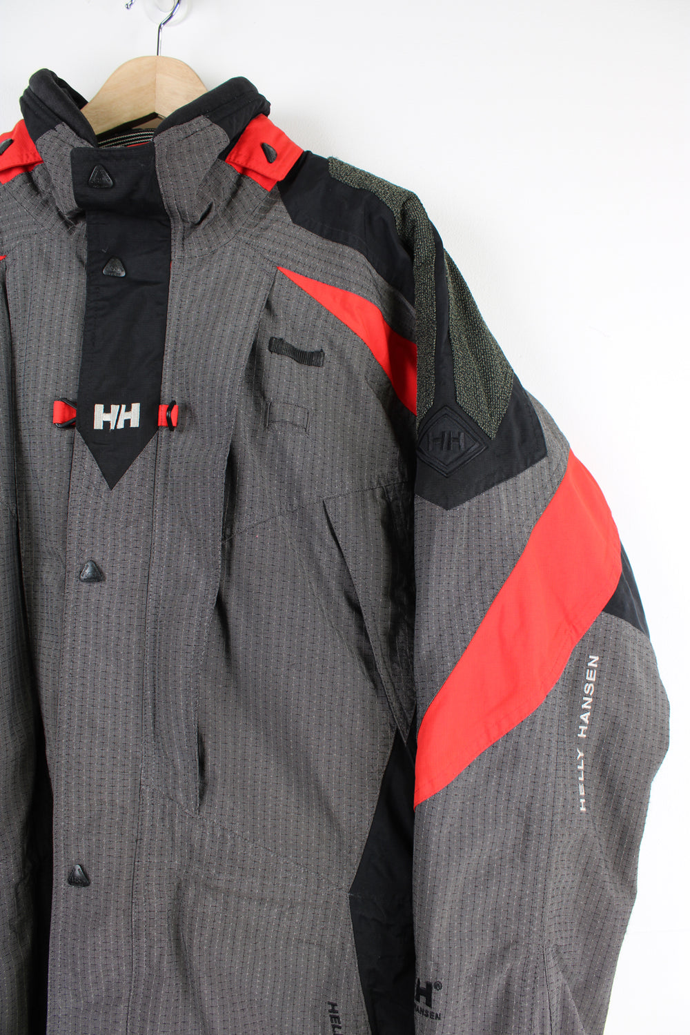 Vintage red and grey Helly Hansen, Helly Tech waterproof jacket, features multiple pockets and embroidered spell-out details on the chest and arm