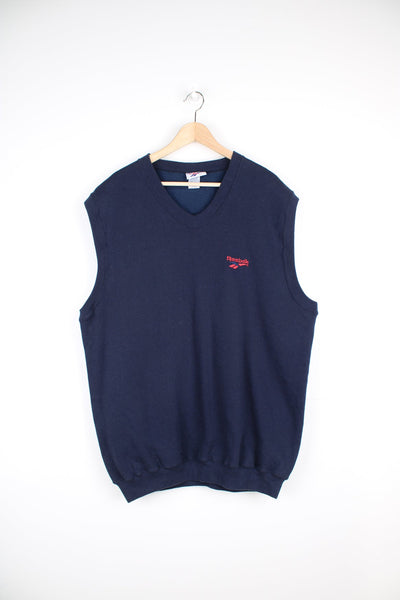 Vintage Reebok sweater vest in navy blue, features red embroidered logo on the chest 