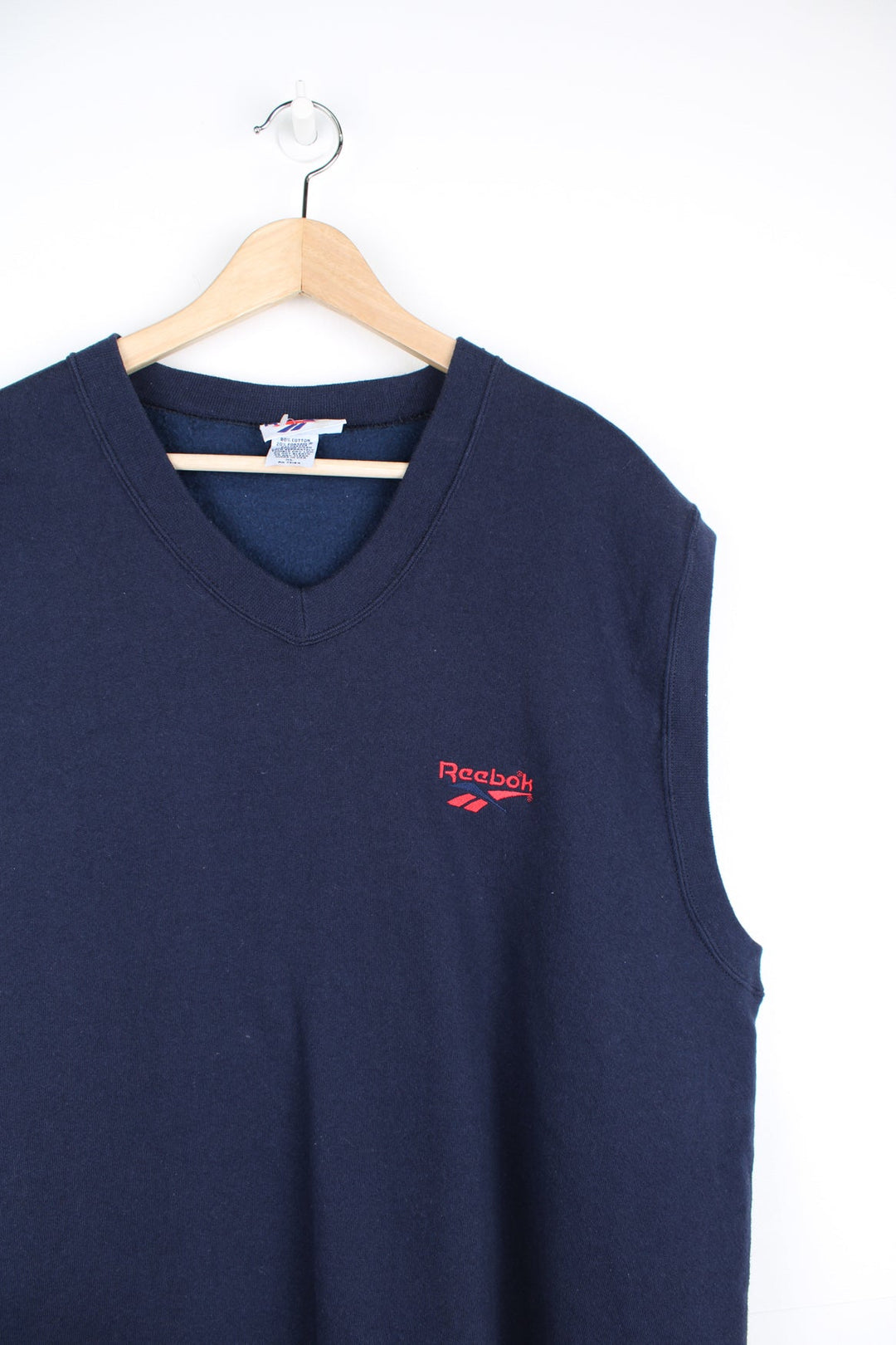 Vintage Reebok sweater vest in navy blue, features red embroidered logo on the chest